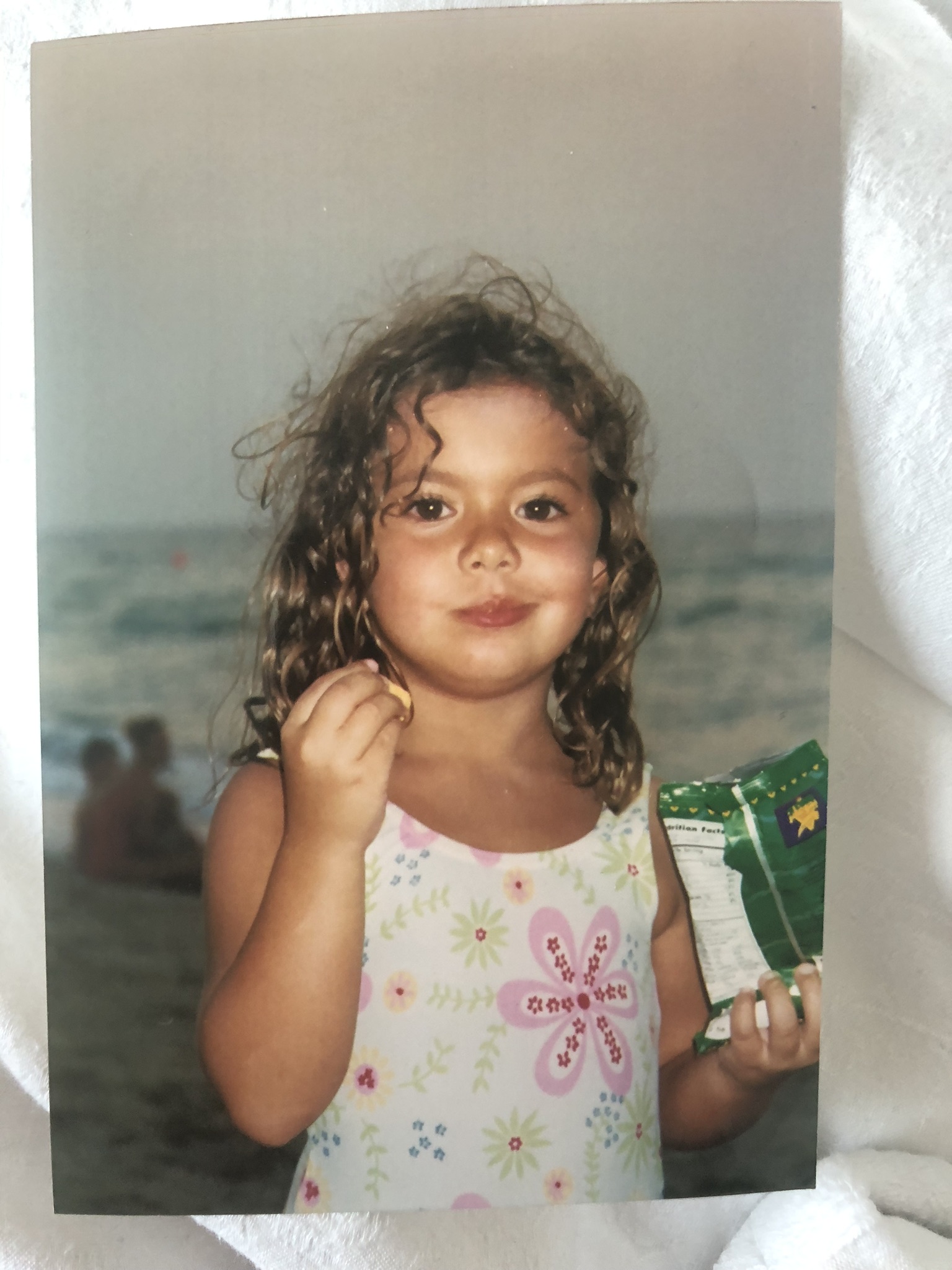 Eva enfant, aux cheveux bouclés.